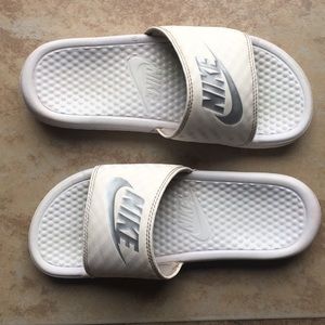 All white Nike sandals